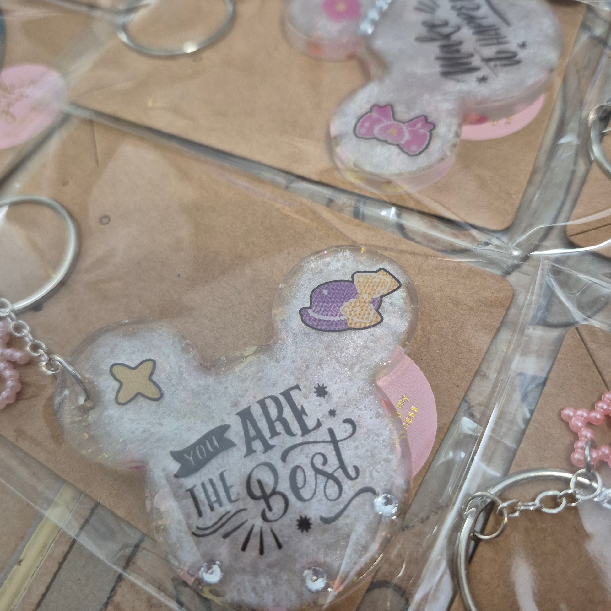 M. Mouse keychains. Message in front and hearts from behind.